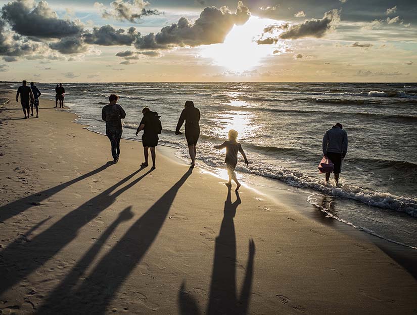 Family walking on beach next to the sea who could in the future need Family Law Blackpool services